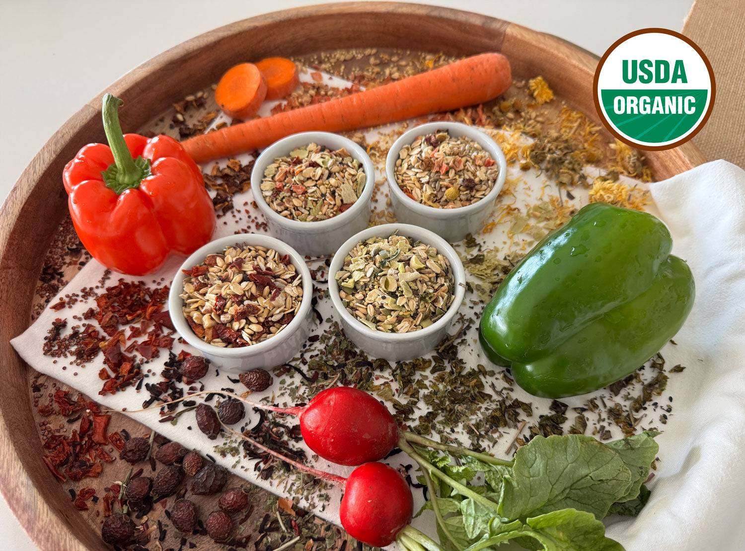 A beautifully arranged tray of Beakology blends with fresh veggies arranged on the tray.