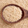 brown rice arranged in a large wooden spoon