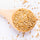 white quinoa in a large wooden spoon